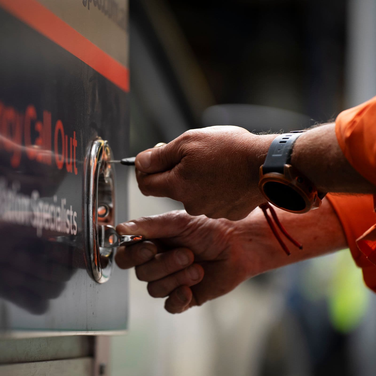 A tradesperson unlocking a secure storage compartment
